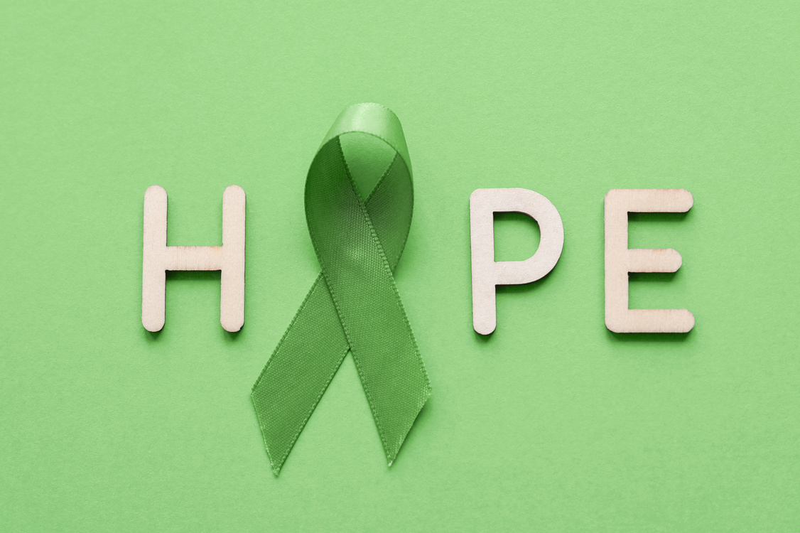 HOPE made from wooden letter with Lime Green Ribbon on green background, Mental health awareness and Lymphoma Awareness, World Mental Health Day